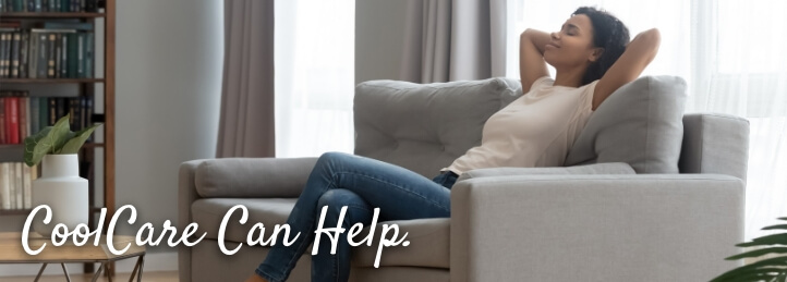 Woman sitting on a couch inside