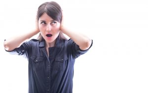 woman-covering-ears-with-shocked-expression-on-her-face