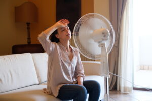 overheated-person-sweating-in-front-of-a-fan